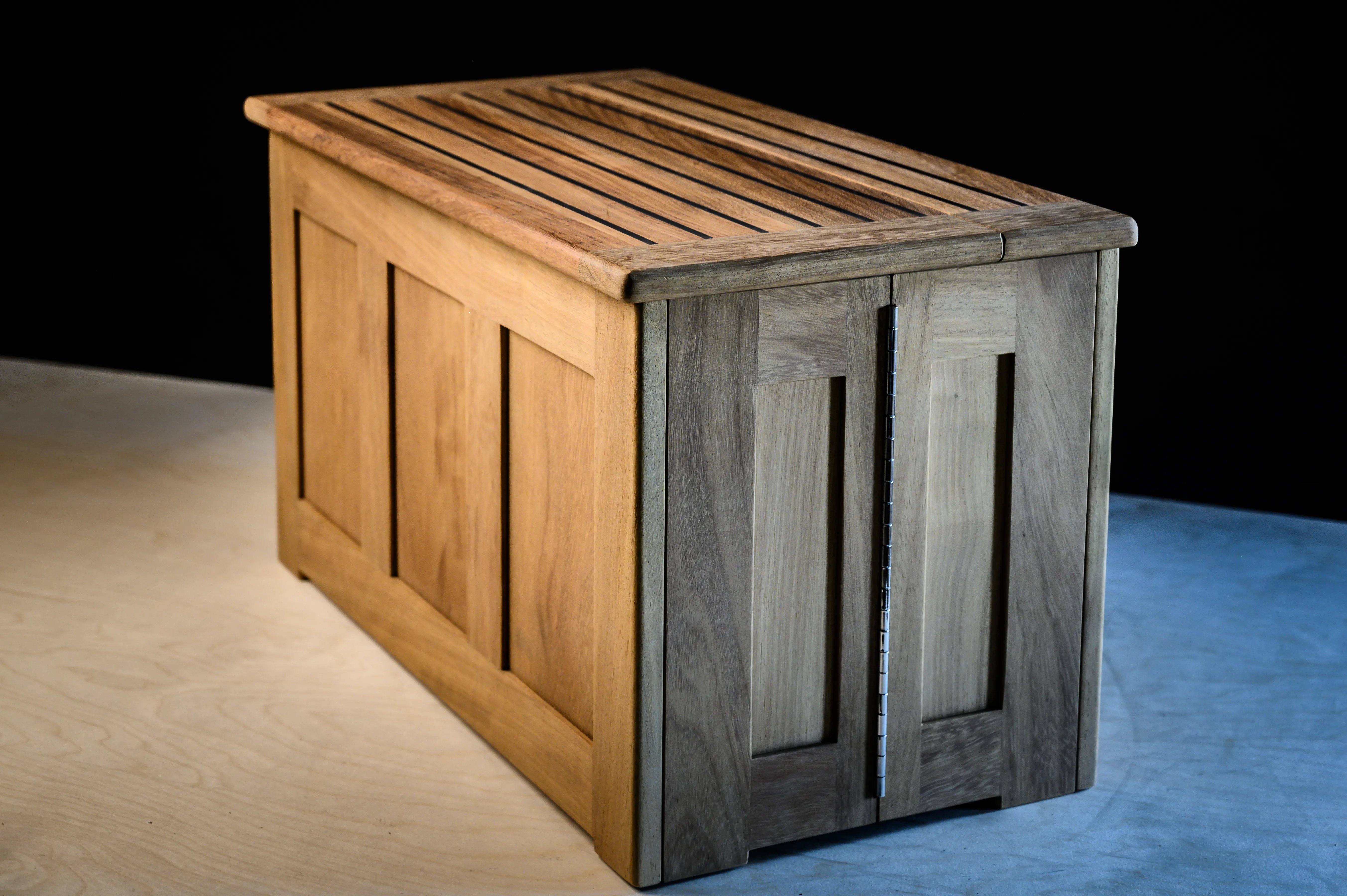 Folding shoe box deployed with slatted top showing interior